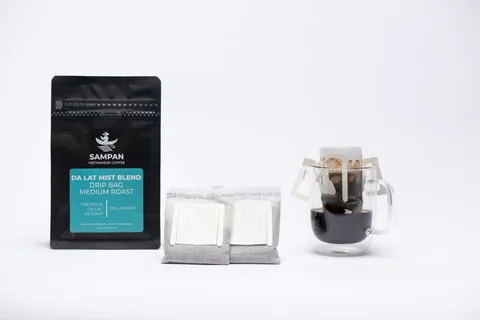 Sampan drip-bag format overview: a coffee bag, individual sachets, and a freshly brewed cu