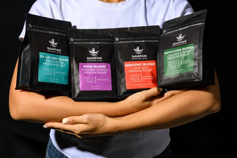 The four Sampan coffee blends — Phin, Indochine, Mekong and Da Lat Mist — arranged with br
